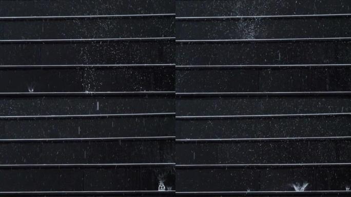 黑色楼梯台阶上下雨时，慢动作速度关闭掉落模式的场景，雨季雨滴的颗粒质地，雨后淹没街道。