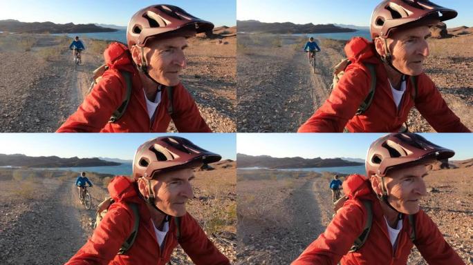 山地自行车手登上沙漠山脊的第一人称视角