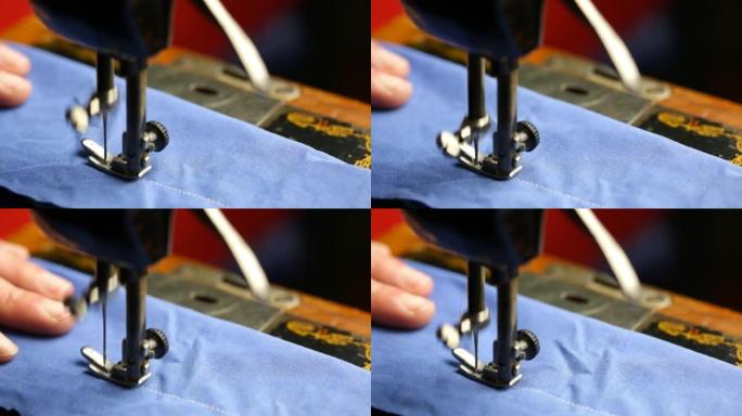 男子在缝纫机上缝制蓝色织物