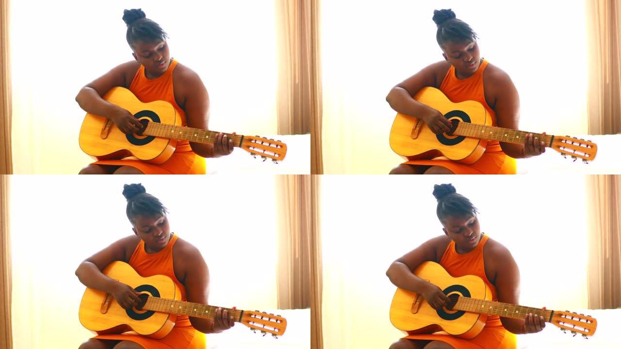 非裔美国少女练习原声吉他的技巧