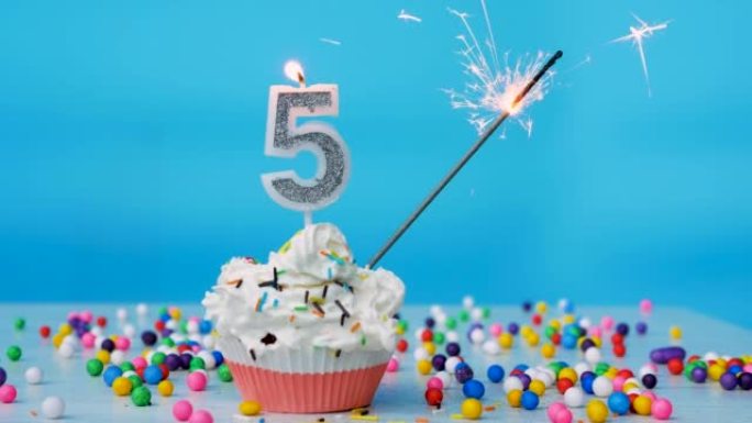 祝5岁的孩子生日快乐，生日蛋糕上有蜡烛和蓝色的背景装饰。本空间