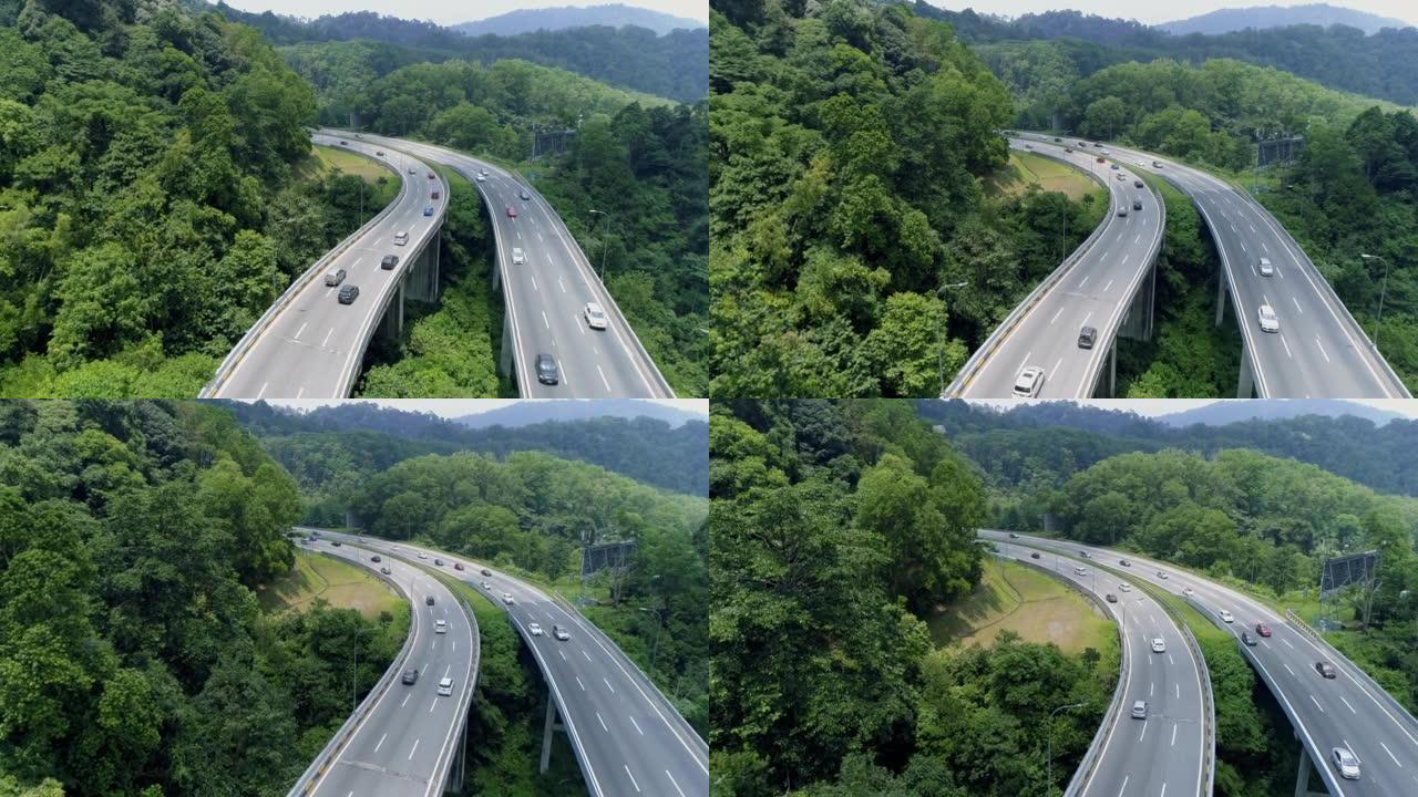 绿色森林4k之间有迎面而来的两条高速公路的鸟瞰图
