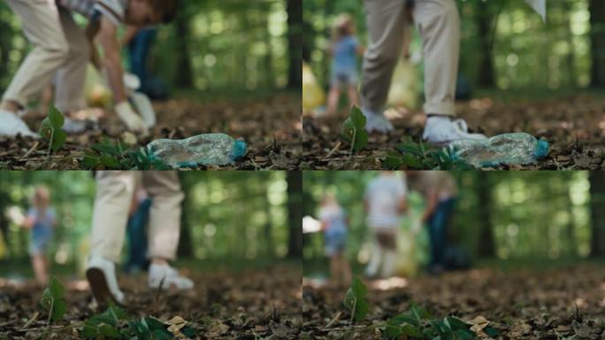 森林里的塑料瓶被男孩和家人带走。用4K红氦相机拍摄。