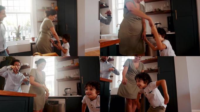 厨房里有趣的家庭时刻: 爸爸妈妈和他们的儿子在家里跳舞