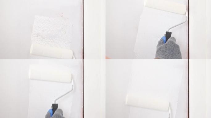 一个男人把木门涂成白色。画家用泡沫涂料滚筒涂白色丙烯酸涂料