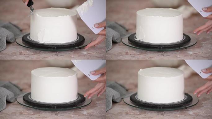 糕点女人在分层蛋糕上撒上奶油的特写。