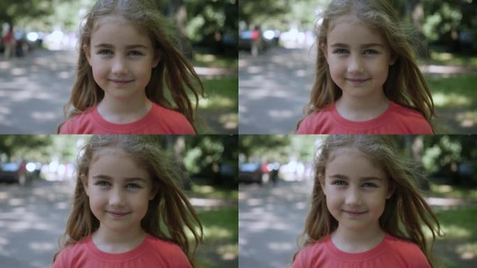 年轻快乐的好奇心孩子在户外看相机特写。面对严肃沉思的孩子。夏天，肖像小女孩站在城市的街道上看着相机。