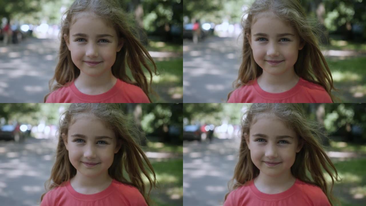 年轻快乐的好奇心孩子在户外看相机特写。面对严肃沉思的孩子。夏天，肖像小女孩站在城市的街道上看着相机。