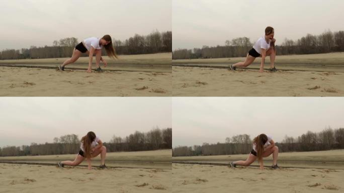 一位迷人的红发女运动员在沙滩上做体操