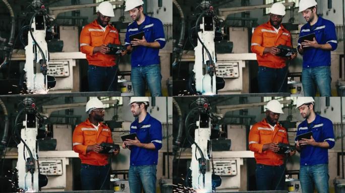 两名工程师致力于控制和编程制造业中的自动化机器人手臂机器。-