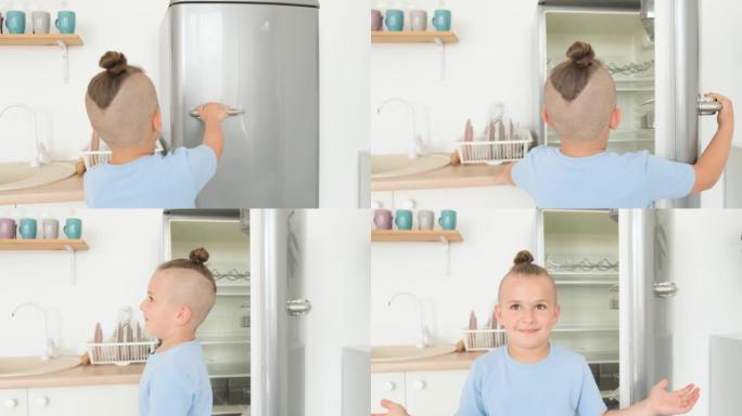 十几岁的男孩在厨房里打开冰箱。空冰箱，食物短缺