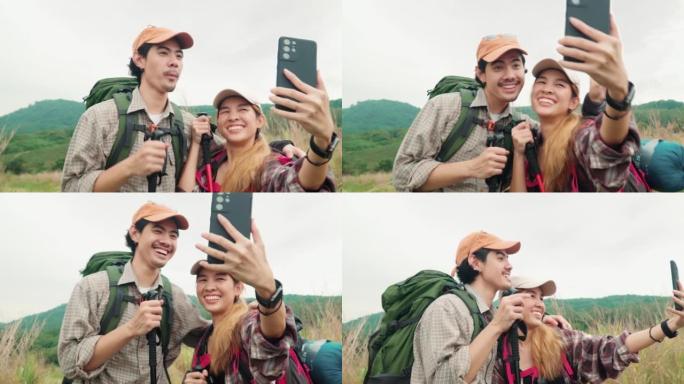 幸福的夫妇在大自然中进行视频通话徒步旅行。