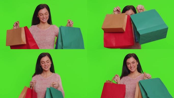 年轻女子展示购物袋，广告折扣，对假期的低价感到惊讶