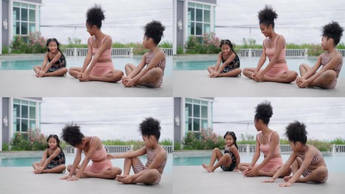运动美丽的中妈妈和两个美国非裔小孩正在做瑜伽，坐在蝴蝶的姿势，腿变成菱形，并试图折叠回脚，以释放下背