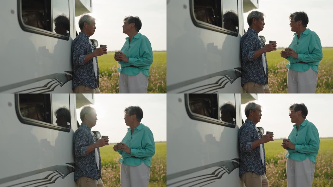 日落时分，亚洲中国高级夫妇在稻田旁的前房车露营车咖啡休息时间