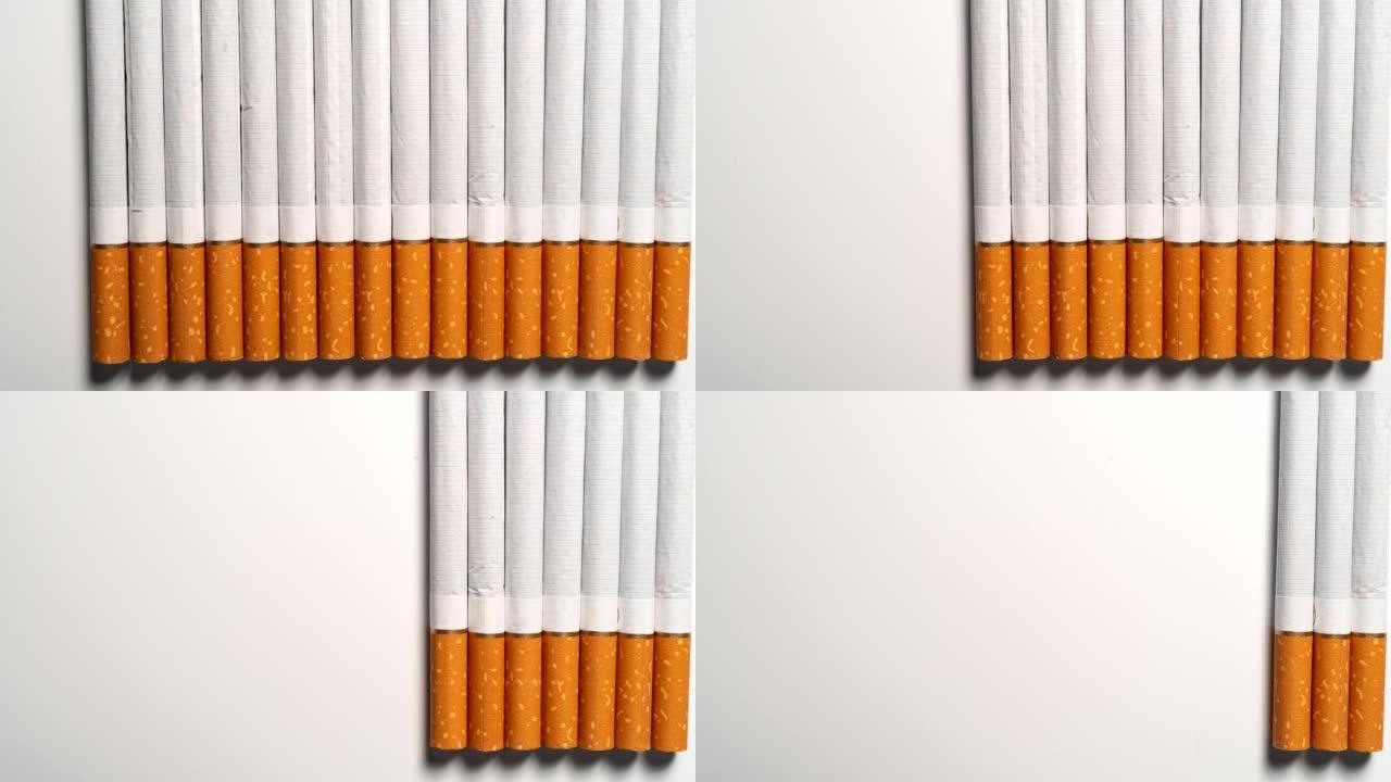 停止运动: 过滤嘴香烟逐渐从白色表面消失