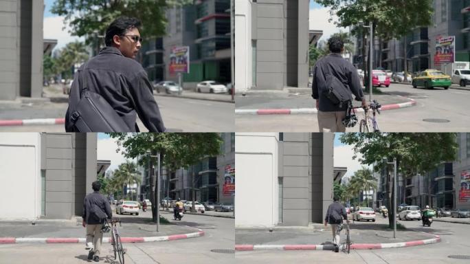年轻的亚洲送货员推着自行车穿过街道。