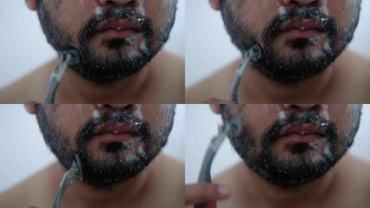 男性剃胡子用手动剃刀特写。英俊的男性刮脸
男人用手动剃刀刮胡子。