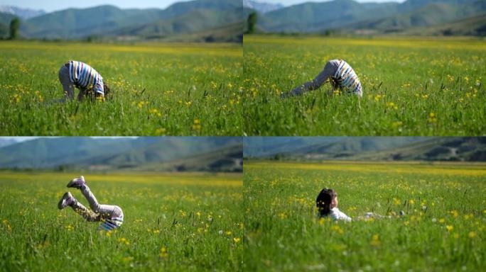 小女孩在草坪上翻筋斗