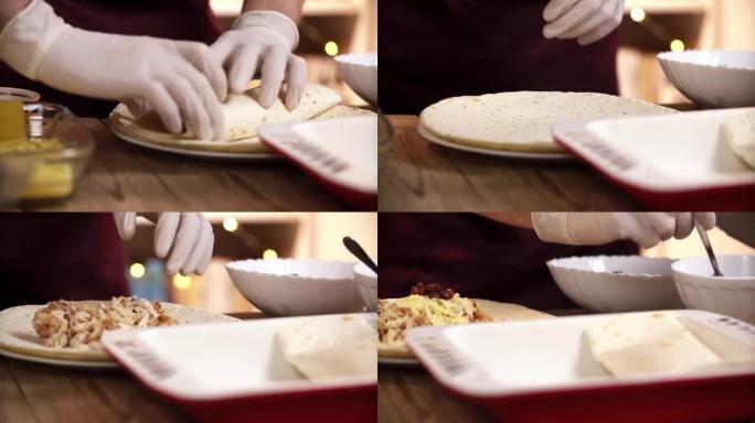 高加索厨师将沙拉馅料放入玉米饼中，用于在餐厅厨房中完成的玉米卷饼