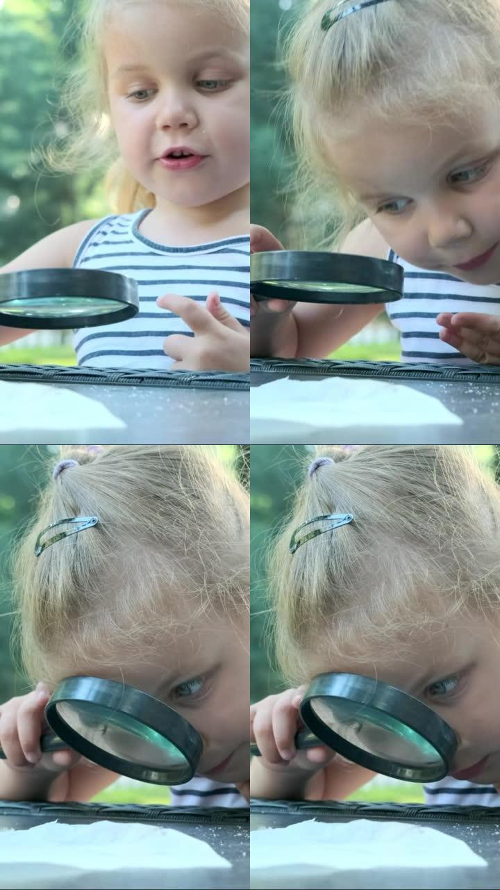 垂直视频: 小女孩仔细地看着盐的镜头。金发女孩的特写镜头正在研究盐晶体，同时坐在公园的街头咖啡馆里，