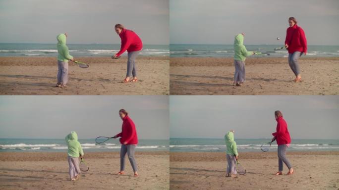孩子和妈妈在海边打沙滩网球