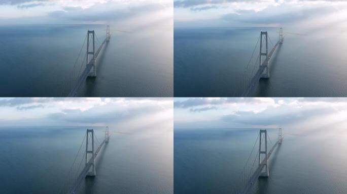 丹麦日落时在大皮带吊桥 (ø stbroen) 高速公路上的汽车交通鸟瞰图
