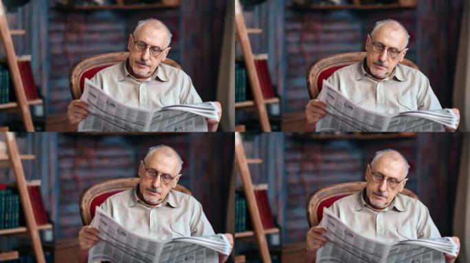 白发老成熟男人戴眼镜阅读日报印刷报纸复古扶手椅