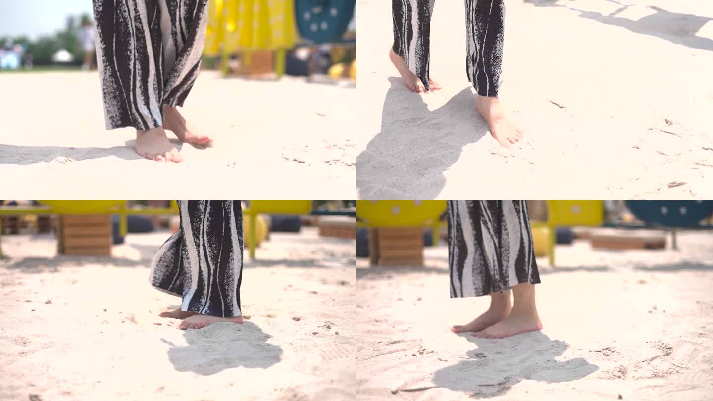 女孩光脚在沙滩玩沙跳跃脚特写