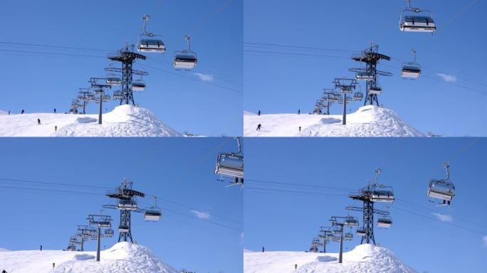 滑雪缆车在奥地利阿尔卑斯山的雪域景观上移动。