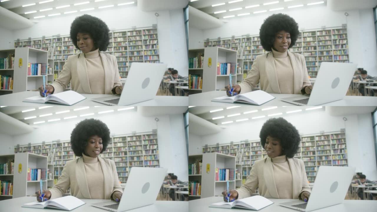 穿着西装的非裔美国妇女在网上做笔记