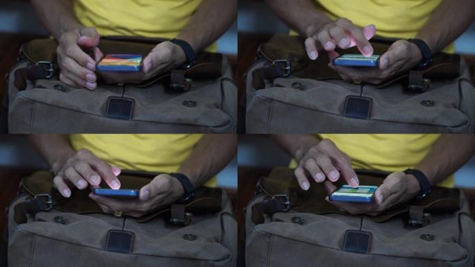 近镜头在手男子用智能手机上网上网网购