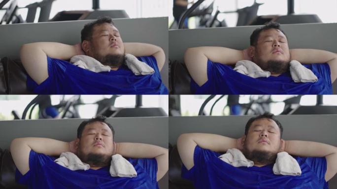在健身中心运动课后，胖乎乎的家伙躺在沙发上睡觉的特写镜头。