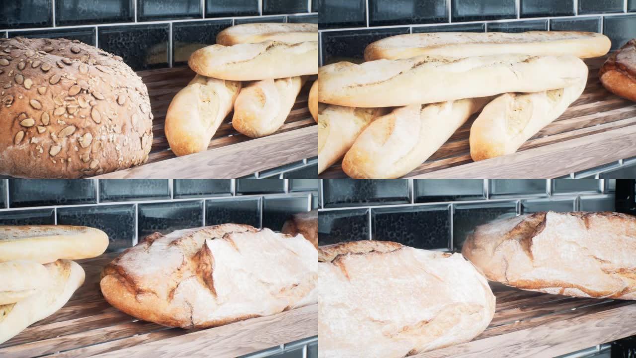 新鲜出炉的面包和酥脆开胃的面包。全麦面包和法式长棍面包的特写。一条面包，吃的概念。动画非常适合食物和