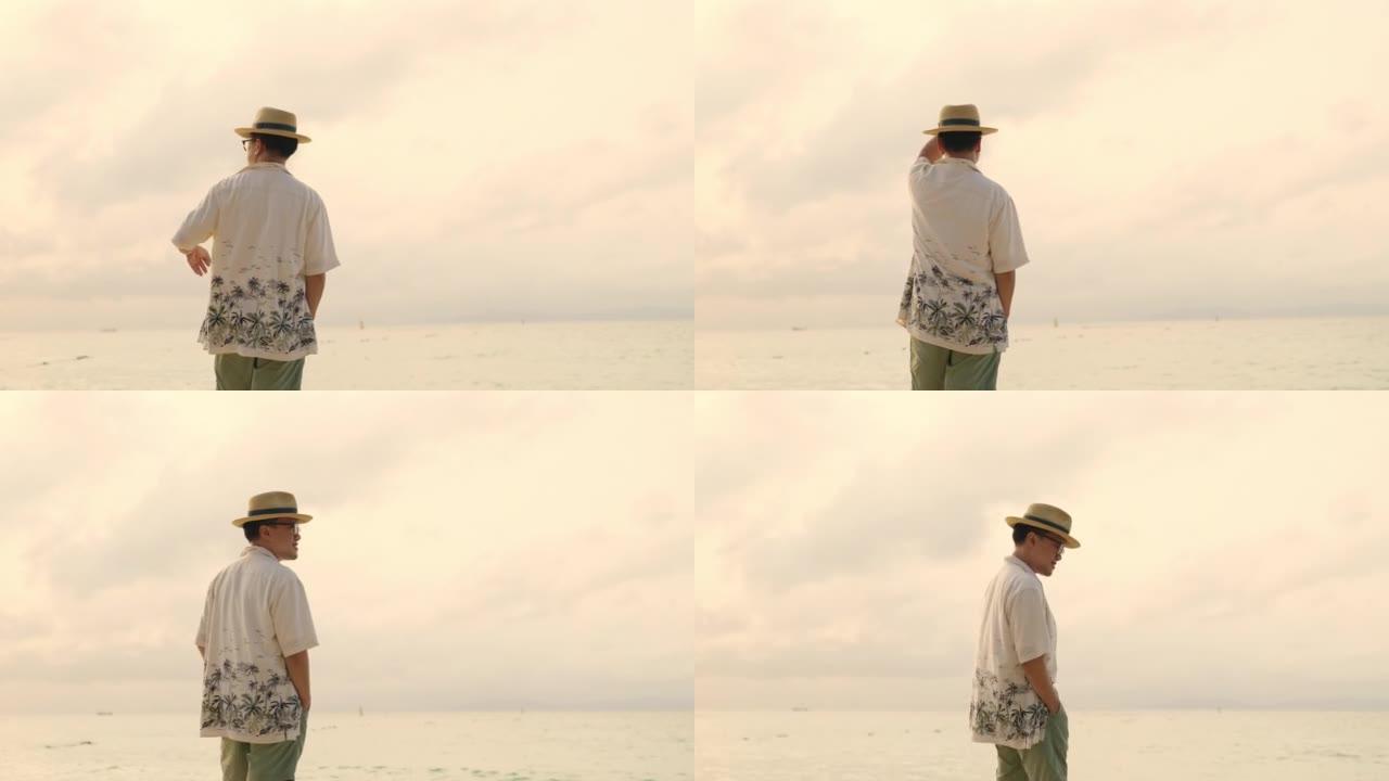 夏季日落时在热带海滩上行走的亚洲男子的4k肖像