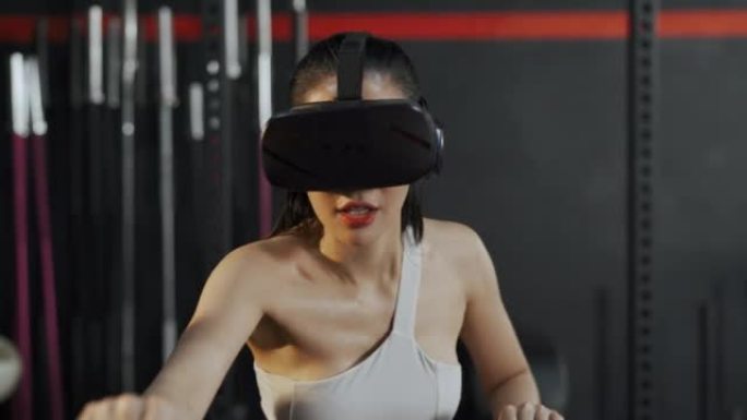 戴着VR耳机和骑自行车的亚洲女性