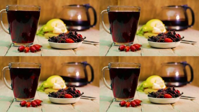 在木板上的透明杯子中的红茶，玫瑰果酊，由红色浆果制成的顺势疗法药茶
