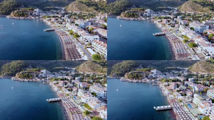 土耳其图伦克度假村海滨码头和海滩的无人机视图。被群山环绕的旅游度假小镇
