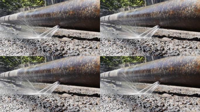 高压下从金属爆裂水管喷出的水和飞溅物。管道设备的折旧导致公用事业故障和饮用水供应中断