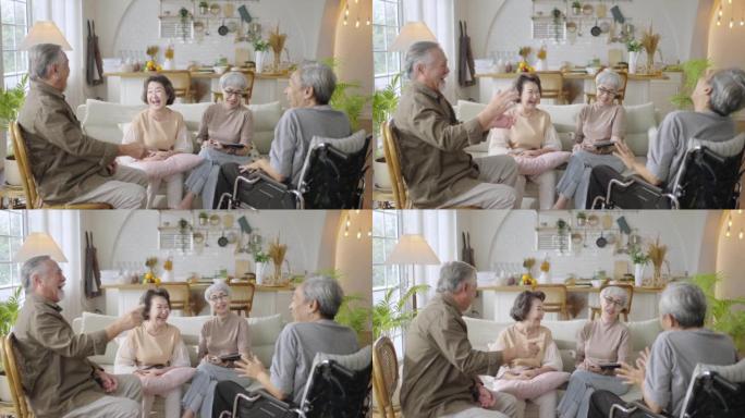 团体亚洲老年人朋友一起坐在家里的客厅里，一起享受聊天。