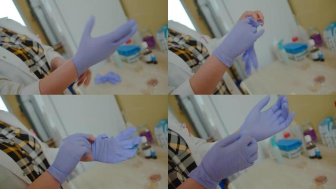 医生或护士戴上蓝色丁腈手术防护手套