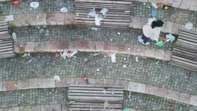 一名妇女收集垃圾的无人机拍摄