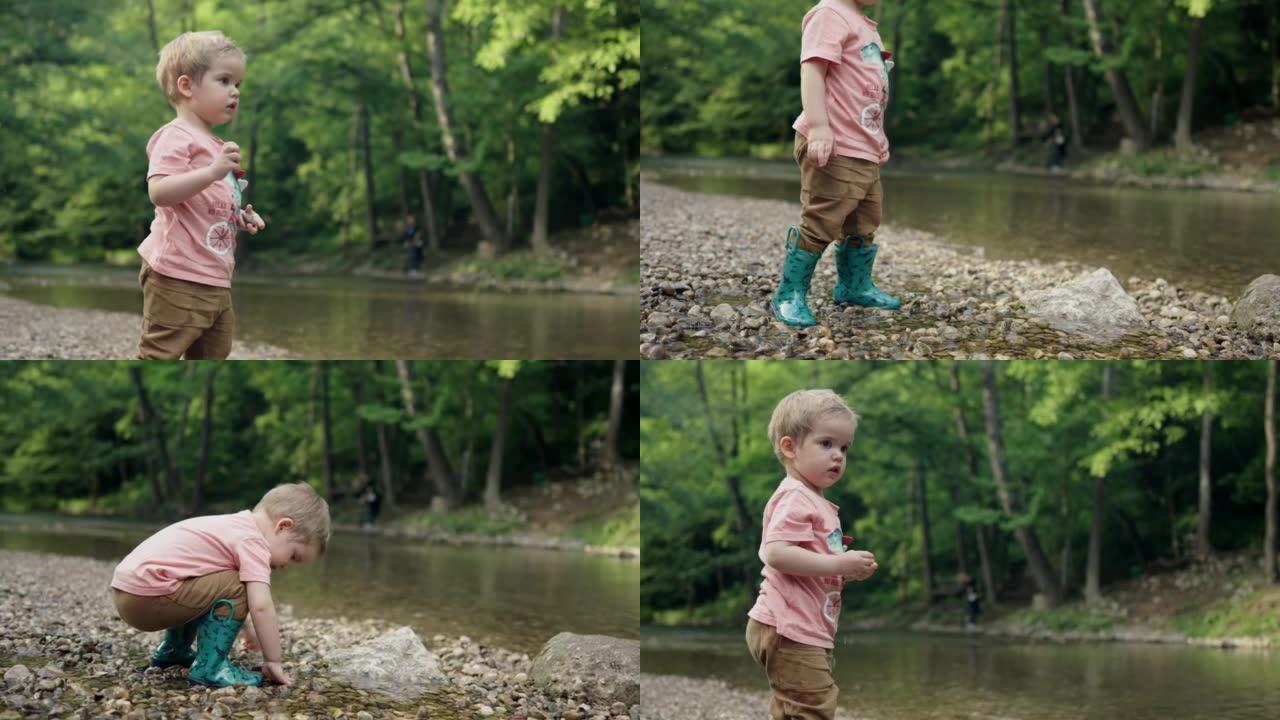可爱的小孩在水中扔鹅卵石