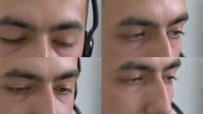 一个戴着耳机的欧洲家伙的极端特写，多变的眼睛，忙于工作，与客户交流。支持服务概念。