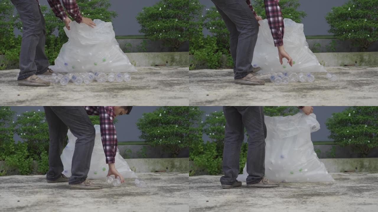 一个年轻人收集透明塑料瓶以回收或作为完整收入出售的4k视频。