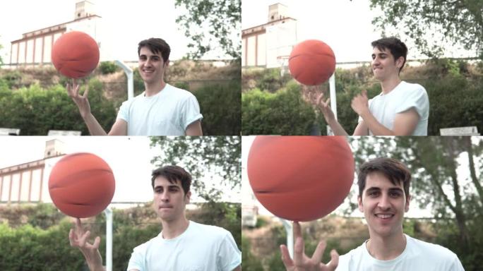 年轻的篮球运动员男孩用一根手指滚动球。