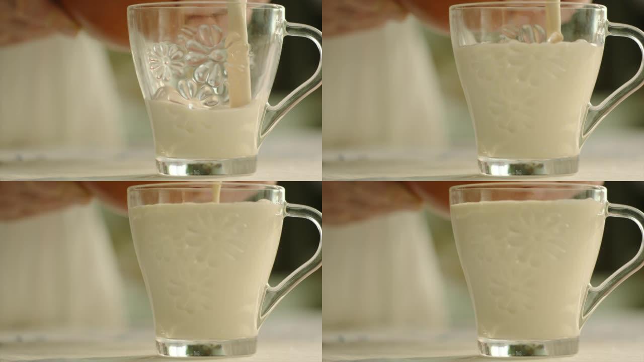 关闭将牛奶倒入乡村的玻璃杯中