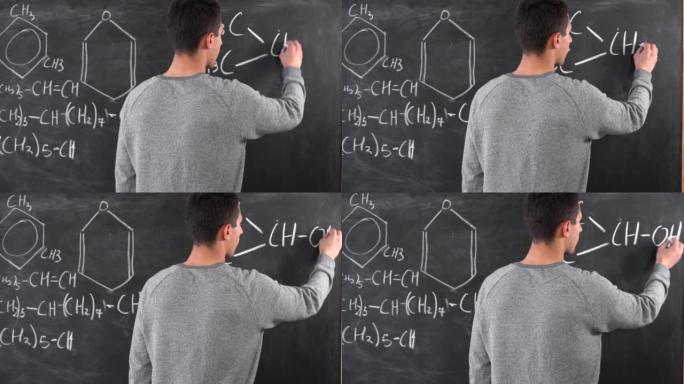 人的手在黑板上画化学方程式。在学校上课。阿拉伯人写了一个复杂的方程式。