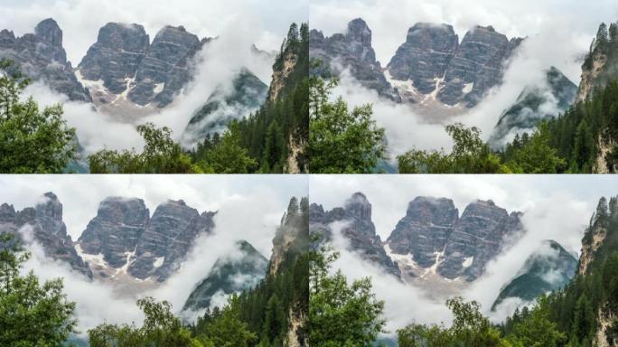 延时的日落场景，云朵在意大利白云岩的杉树上移动。