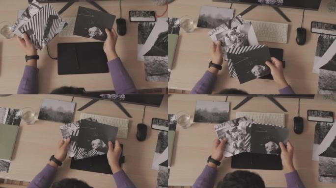 摄影师观看打印的黑白照片的俯视图